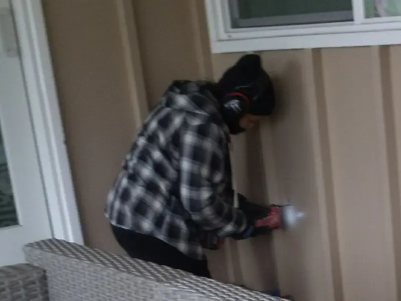 Professional electrician installing an exterior outlet in St. Michael
