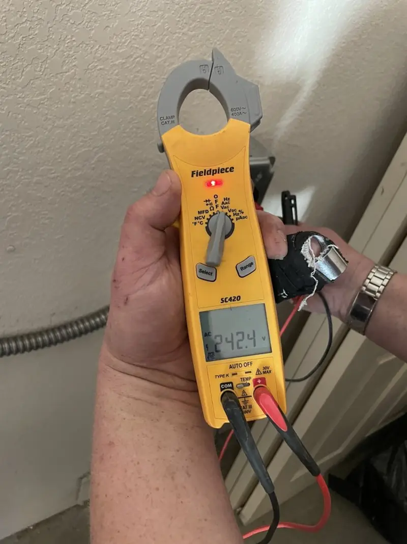 Voltage testing with clamp meter during Outlet Installation in St. Michael